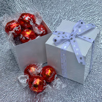 White cube box filled with Lindt ball chocolates